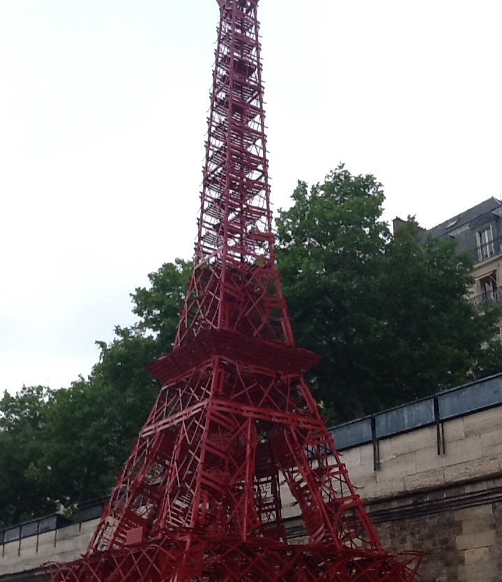 This mini red Eiffel Tower is completely constructed out of metal cafe chairs.